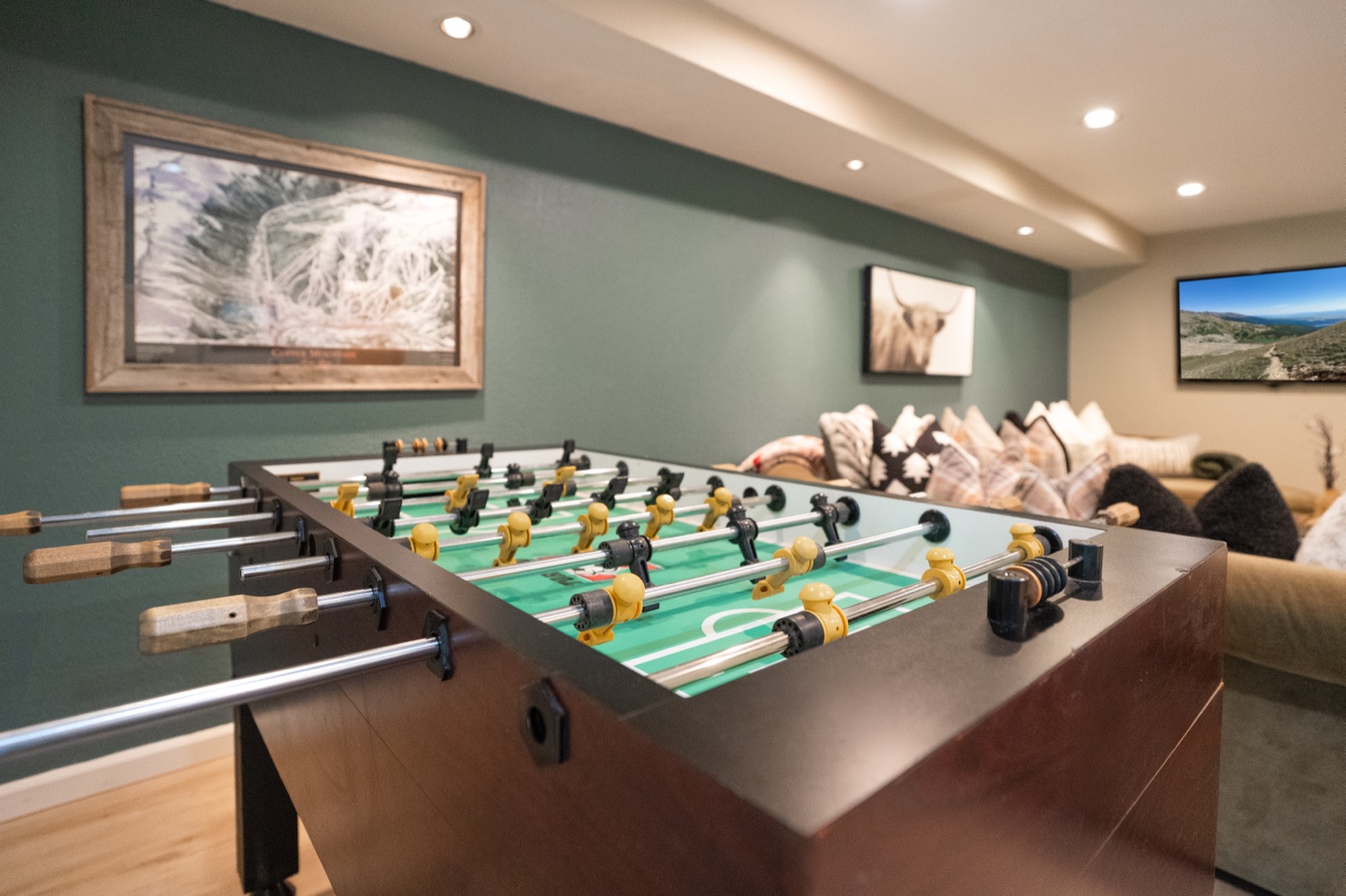 Game room with foosball table, mountain art, and cozy seating